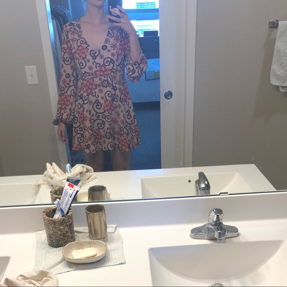 Summery low-cut dress with large slit in the back